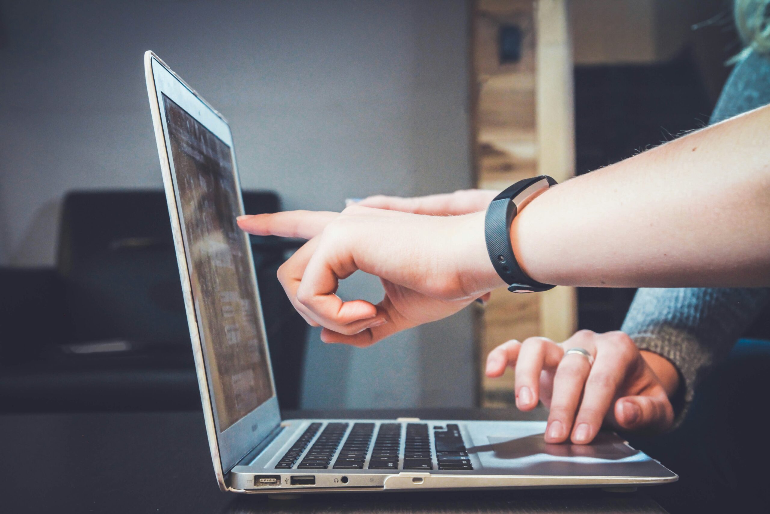 pointing at the laptop screen